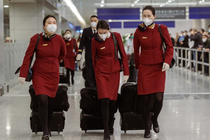 Cabin crew prepare to leave Pudong International Airport, in Shanghai. EPA