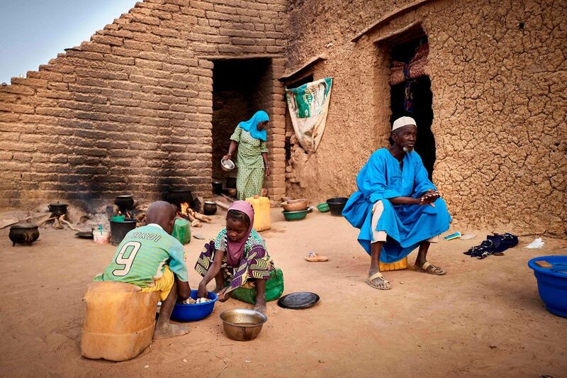 A displaced family is seen in a courtyard of Sevare where they found a shelter after fleeing their village of Guerri in central Mali, on February 27, 2020.  In January 2019 Jihadists broke in the village, setting fire on it, killing 3 villagers, and stealing all the livestock. AFP