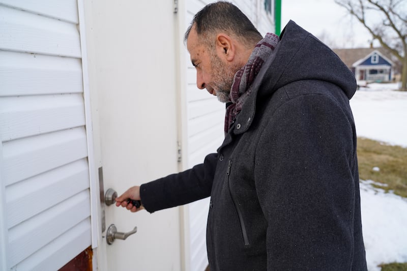 Imam Taha Tawil unlocks the back door of the mosque in Cedar Rapids, Iowa. 