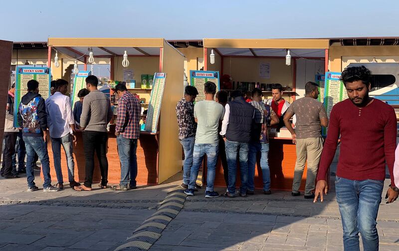 DUBAI, UNITED ARAB EMIRATES , Jan 30  – 2020 :- People trying their luck in the Lucky Games kiosk near the creek in Bur Dubai area in Dubai. ( Pawan  Singh / The National ) For News. Story by Anna