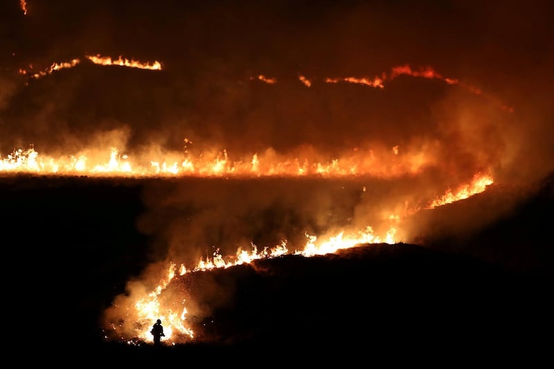 A fire is seen burning on Saddleworth Moor near the town of Diggle, Britain. Reuters