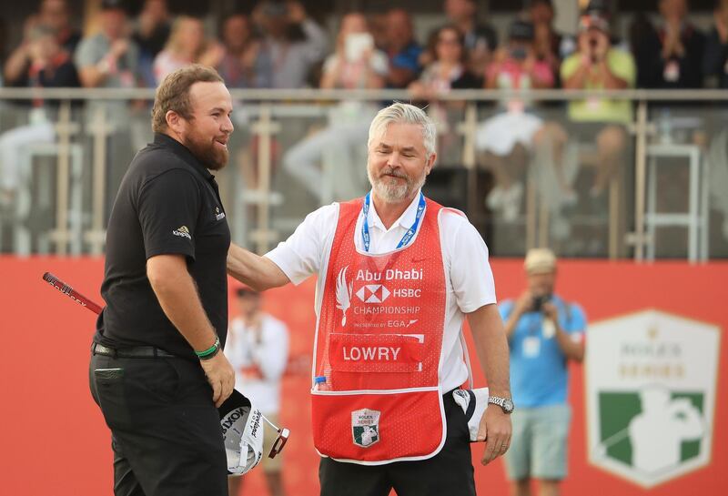 Lowry celebrates with his caddie Brian Martin.