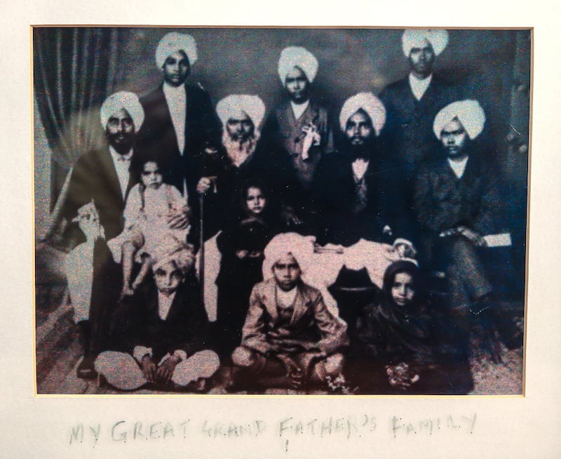 Narindra Singh Pujji's father Teja Singh Pujji, standing, back left, grandfather, seated, left, and great grandfather, seated, second left, with relatives at a family gathering in present-day Pakistan. Victor Besa / The National