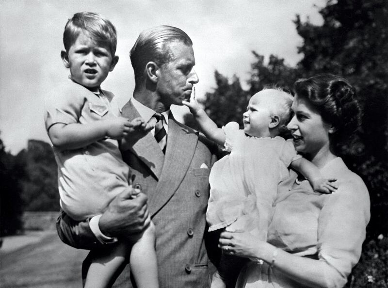 Undated picture showing the Royal British couple, Britain's Queen Elizabeth II, and her husband Britain's Prince Philip, Duke of Edinburgh, with their two children, Charles, Prince of Wales (L) and Princess Anne (R). (Photo by - / AFP)