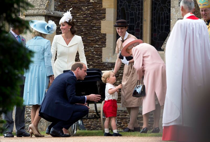 Having a word with his great-grandmother Queen Elizabeth II at the July 2015 christening of Princess Charlotte on the Sandringham estate. Getty Images
