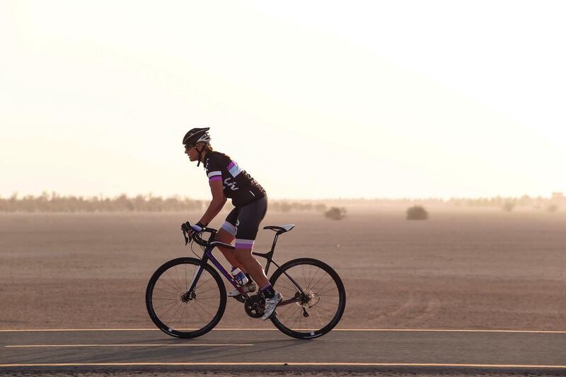 Emma Woodcock cycles even through the hot summer months to keep fit. Seen here during a ride at the Al Qudra track near Bab Al Shams. Antonie Robertson / The National
