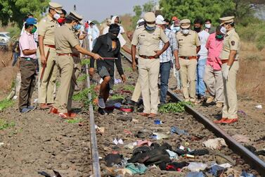 Police officers examine the railway track where a train ran over sleeping migrant workers in Aurangabad district in the western state of Maharashtra, India on May 8, 2020. Reuters