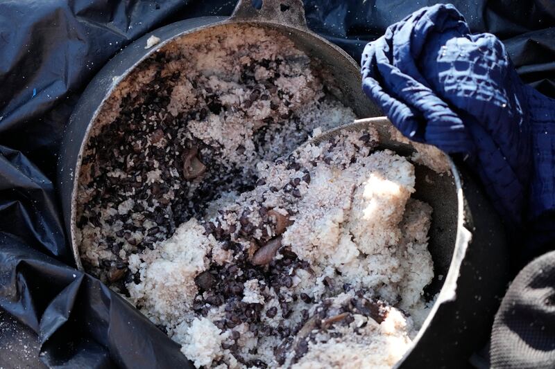 A container with beans and rice lies abandoned in a migrant boat. AP