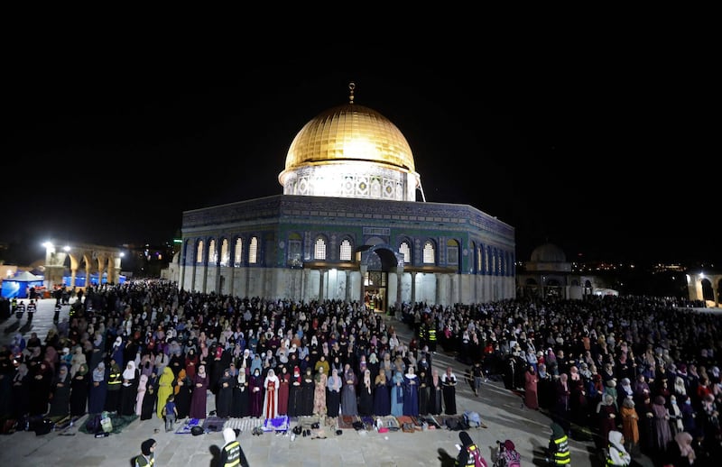Palestinian devotees pray as they seek Laylat Al Qadr or the Night of Destiny outside the Dome of the Rock in Jerusalem's Al Aqsa Mosque compound. AFP