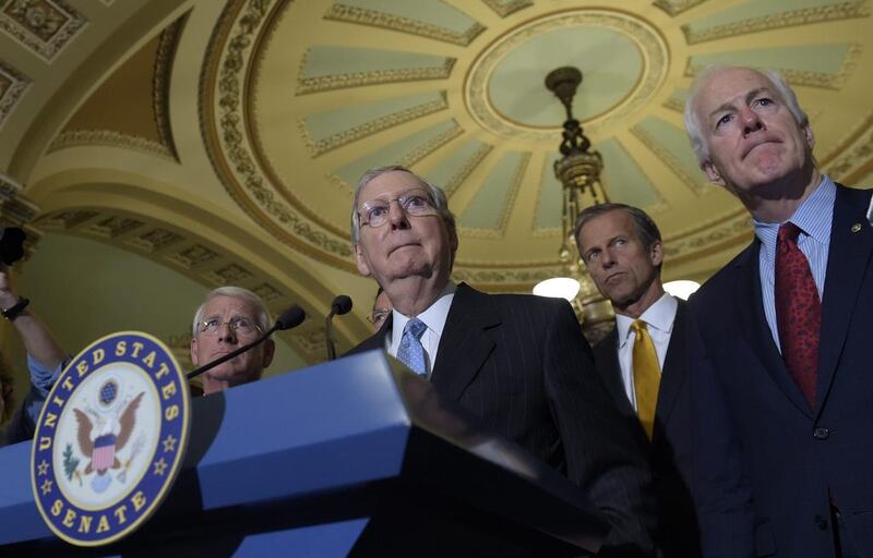 Senate majority leader Mitch McConnell with Sen Roger Wicker, Sen John Thune and Sen John Cornyn. Susan Walsh / AP