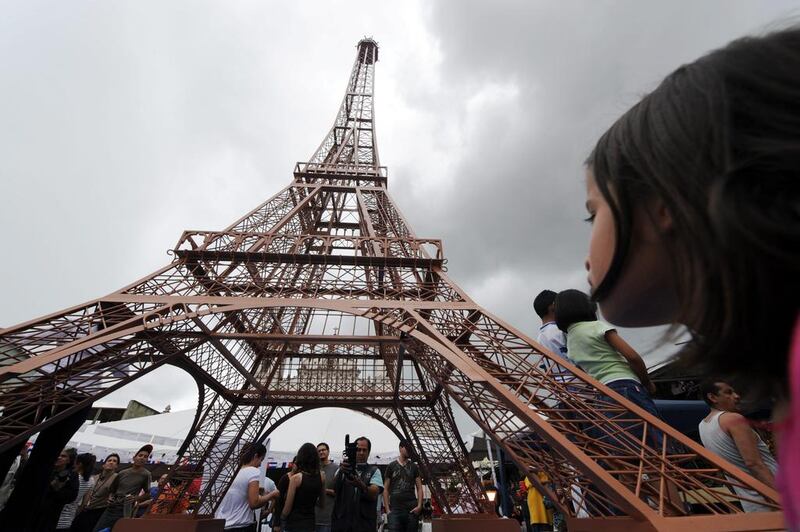 A girl looks at an eight-metre tall Eiffel Tower in Tegucigalpa, Honduras. Orlando Sierra / AFP Photo