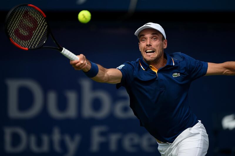 DUBAI, UNITED ARAB EMIRATES - FEBRUARY 27: Roberto Bautista Agut of Spain plays a forehand during his match against Pierre-Hugues Herbert of France on day three of the ATP Dubai Duty Free Tennis Championships at the Dubai Duty Free Stadium on February 28, 2018 in Dubai, United Arab Emirates.