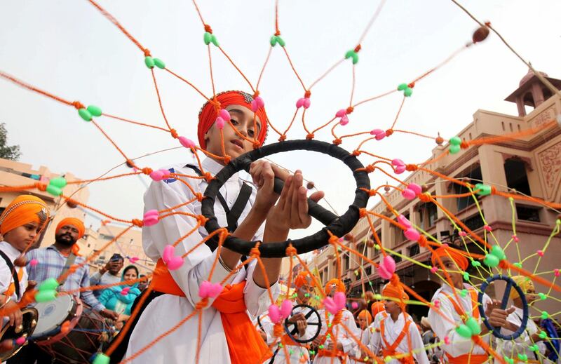 A Sikh boy performs 'Gatkha', a traditional form of martial arts during a religious procession on the eve of the 550th birth anniversary of Guru Nanak Dev, the first Sikh Guru and founder of Sikh faith, in Amritsar, India. REUTERS