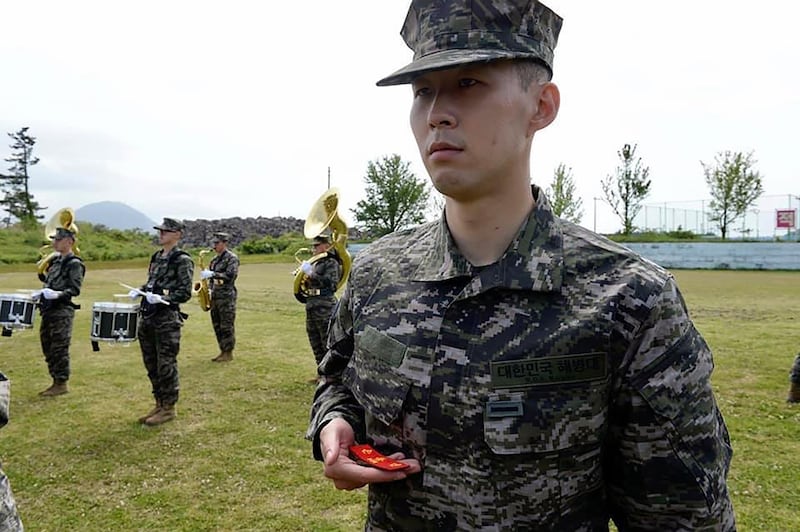 Son Heung-min holds his name tag during a basic military training completion ceremony at a Marine Corps boot camp in Seogwipo on Jeju Island.