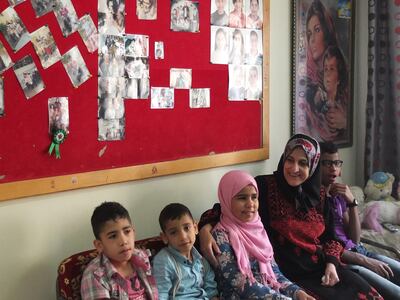 May 28/16-Umm Asmahan is one of the mothers caring for 6 orphaned children inside her home. Orphans in Irbid, Jordan. At the Irbid branch of SOS Children's Village. They are a musical group of orphans who love to sing, and their dream is to go to the beach. (Rym Ghazal / The National) *** Local Caption ***  proud Umm asmahan and her children, all orphans.jpg