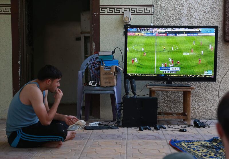 A Syrian fan watches the game in Hamouria, in the eastern Ghouta region. Abdulmonam / AFP Photo
