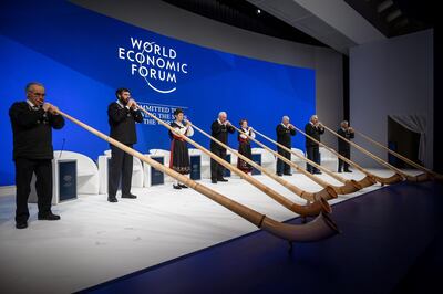 Alphorn blowers perform during the opening of the World Economic Forum (WEF) annual meeting, on January 22, 2019 in Davos, eastern Switzerland.  / AFP / Fabrice COFFRINI
