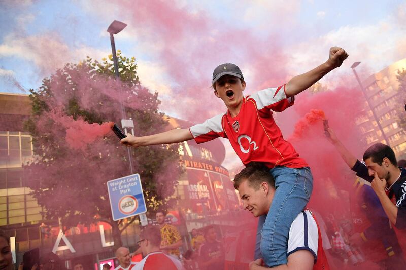 Arsenal fans celebrate outside the Emirates stadium in north London. AFP