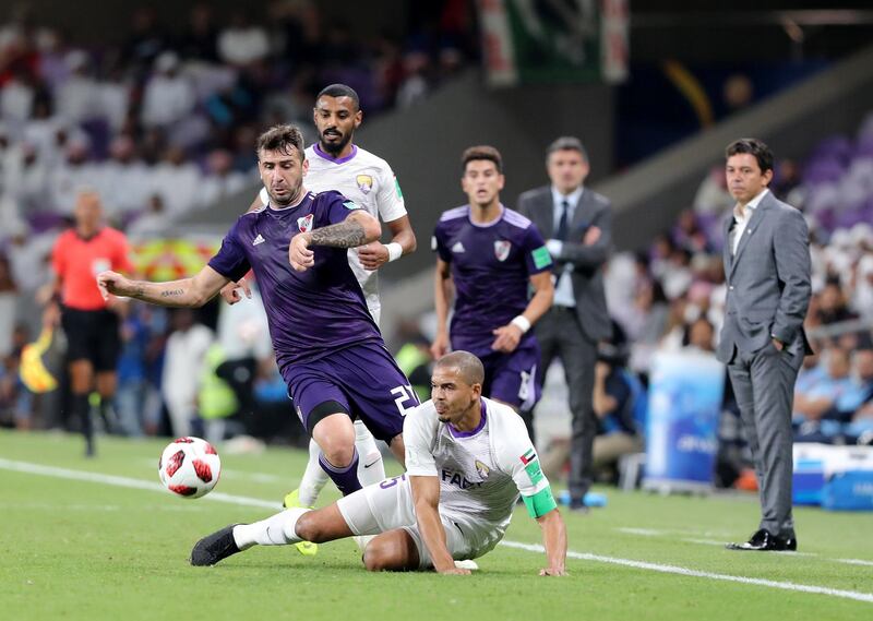 Al Ain, United Arab Emirates - December 18, 2018: River Plate's Lucas Pratto and Al Ain's Ismail Ahmed battle during the game between River Plate and Al Ain in the Fifa Club World Cup. Tuesday the 18th of December 2018 at the Hazza Bin Zayed Stadium, Al Ain. Chris Whiteoak / The National