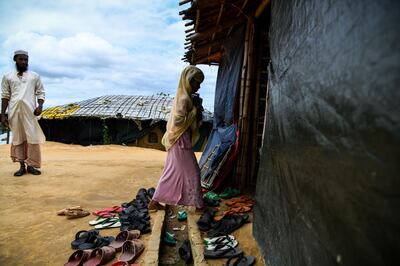 In this photograph taken on August 12, 2018, Saleema Khanam, 8, enters a madrassa (Islamic seminary) for her studies in Kutupalong camp, in Ukhia near Cox's Bazar. Islamic seminaries or madrassas, catering to Rohingya children driven from Buddhist-majority Myanmar by a wave of genocidal violence, are springing up in the world's largest refugee camp in Bangladesh since a massive influx of Rohingya Muslims last year. Formal schooling, which suggests a permanent presence, is not allowed in the camps. For many children, the madrassas are the only places to learn. / AFP / CHANDAN KHANNA
