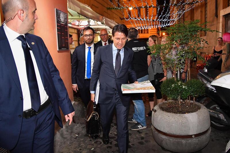 epa06763795 Italian Premier designate, Giuseppe Conte, takes a pizza before returning to his home, Rome, Italy, 25 May 2018.  EPA/ALESSANDRO DI MEO