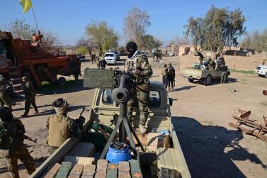 A Shiite fighter at a heavy machinegun on at the outskirts of Balad, north of Baghdad, on December 25, 2014. Reuters