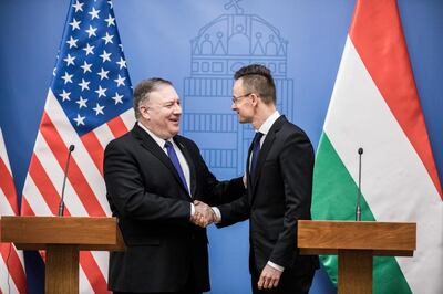 Mike Pompeo, U.S. secretary of state, shakes hands with Peter Szijjarto, Hungary's foreign minister, right, during a news conference in Budapest, Hungary, on Tuesday, Feb. 11, 2019. In a sign that the U.S. policy toward Hungary is switching gears, Pompeo is scheduled to meet with civil society leaders in Budapest before seeing local officials and will also announce a new program to support independent media in central Europe. Photographer: Akos Stiller/Bloomberg