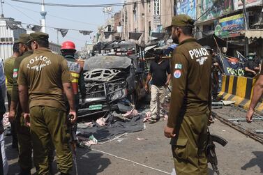 Pakistani security officials examine the site of a bomb blast outside a Sufi shrine in Lahore. AFP