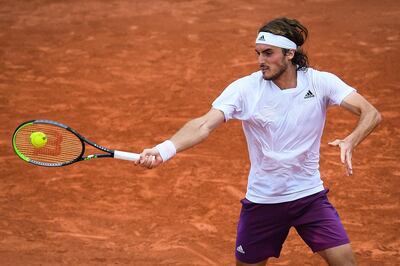 Greece's Stefanos Tsitsipas returns the ball to Spain's Pedro Martinez during their men's singles second round tennis match at the Court Suzanne Lenglen on Day 4 of The Roland Garros 2021 French Open tennis tournament in Paris on June 2, 2021. / AFP / Christophe ARCHAMBAULT
