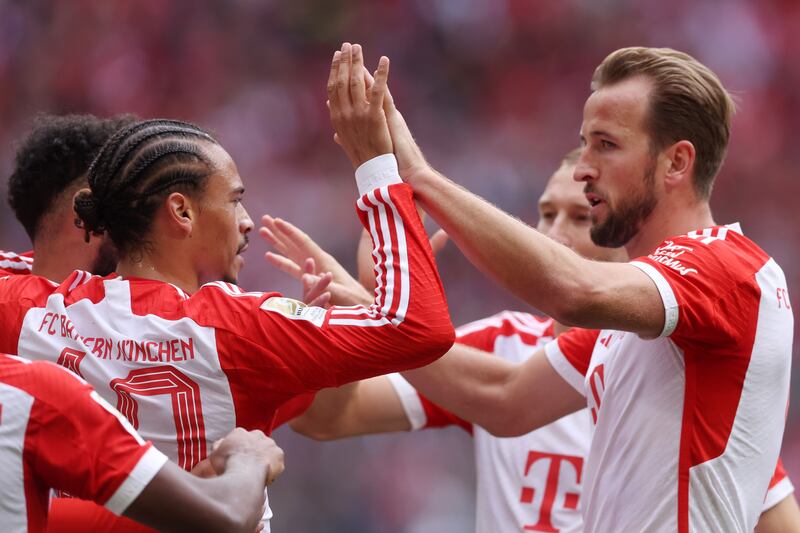 Leroy Sane of Bayern Munich celebrates with teammate Harry Kane after scoring the fourth goal. Getty