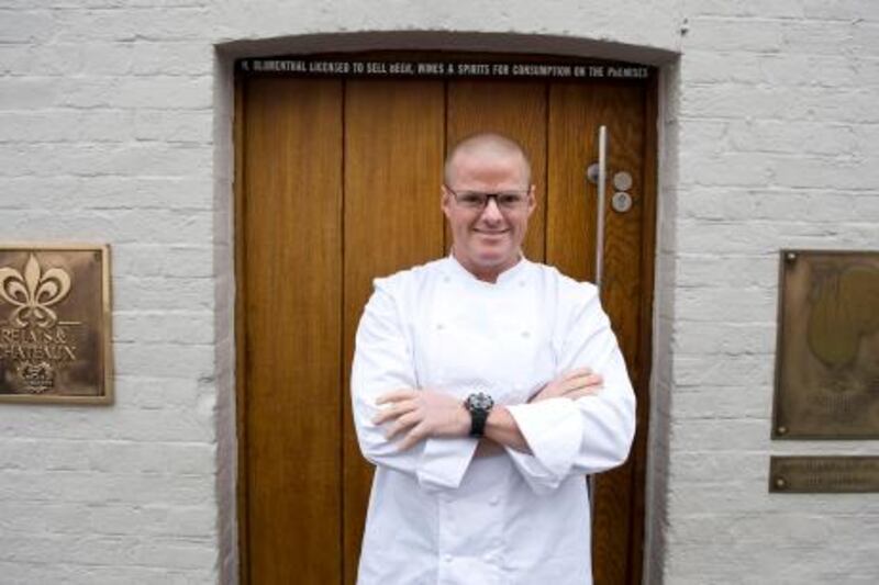 British Chef Heston Blumenthal is pictured at the entrance to the Fat Duck restaurant in Bray, Berkshire, on March 12, 2009. One of the world's finest restaurants, the Fat Duck, is to reopen Thursday, a spokeswoman for British chef Heston Blumenthal told AFP, two weeks after a health scare which hit some 400 diners. The Michelin three starred restaurant in Bray, west of London, closed on February 24 after about 40 customers said they had fallen ill, a figure which rose roughly tenfold following media coverage. AFP PHOTO/Ben Stansall