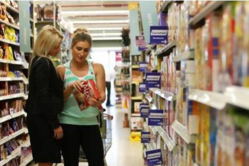 Nadine du Toit , right, takes her client Monique Robinson food shopping at a supermarket in Dubai’s Jumeirah Lakes Towers. Pawan Singh / The Nation