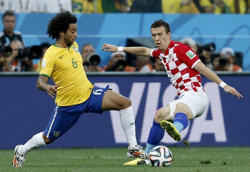 Marcelo, left, of Brazil vies for the ball with Ivan Perisic, right, of Croatia, during their match at the 2014 World Cup on Thursday night. Tolga Bozoglu / EPA