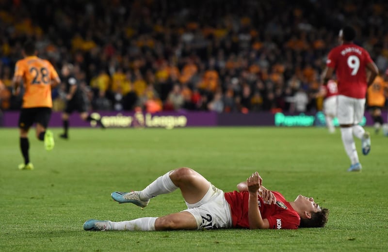 Manchester United's Welsh midfielder Daniel James reacts after a challenge during the Premier League match against Wolves at Molineux. The match ended 1-1. AFP
