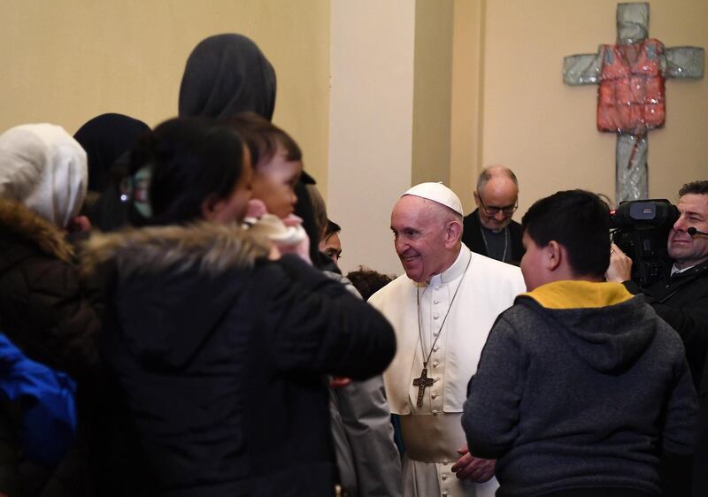 epa08081813 Pope Francis greets refugees coming from the Greek island of Lesbos, at the Vatican, 19 December 2019. The pontiff met with refugees from Lesbos who arrived in recent weeks via the humanitarian corridors project to Italy, media reported.  EPA/ETTORE FERRARI / POOL