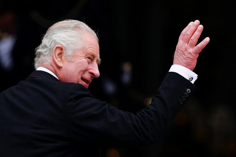 Prince Charles waves to the crowd as he arrives for the service of thanksgiving. AP