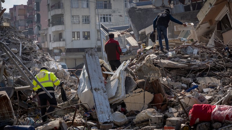 Survivors search through the rubble of what was once their homes 