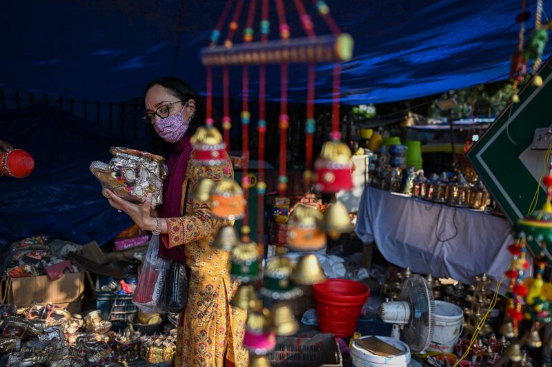 Shoppers buy decorative items in New Delhi. AFP