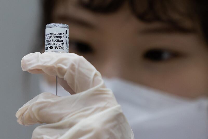 A nurse fills a syringe with a dose of the Pfizer/BioNTech Covid-19 vaccine in Goyang, South Korea. Bloomberg