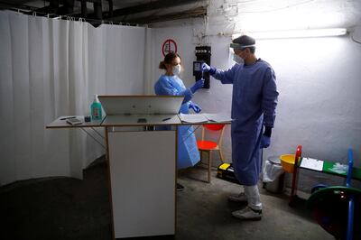 General practitioner Kerem Erekul holds a swab for coronavirus disease (COVID-19) testing at the cellar of his office, formerly used as a World War Two shelter, amid the COVID-19 outbreak in Berlin, Germany November 25, 2020. REUTERS/Fabrizio Bensch