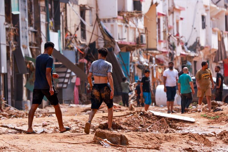 People survey the flood damage in Derna, which was most affected. AFP