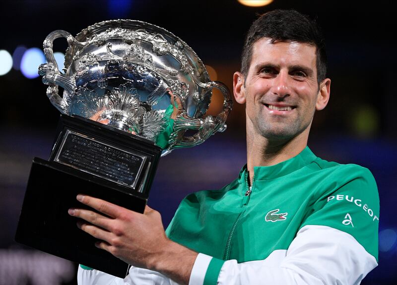 Novak Djokovic holds the trophy after winning the Australian Open in February, 2021. AP