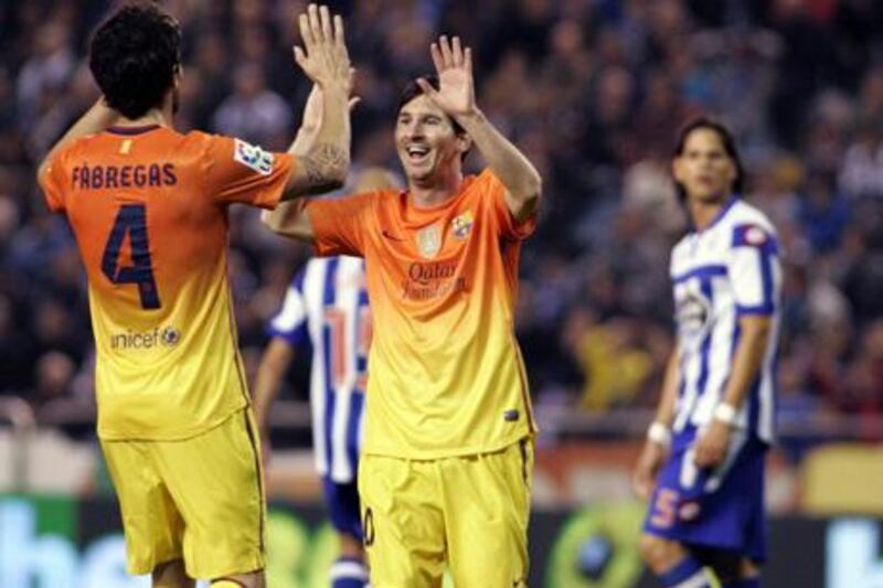 Cesc Fabregas congratulates Lionel Messi after his goal against Deportivo La Coruna at the Riazor