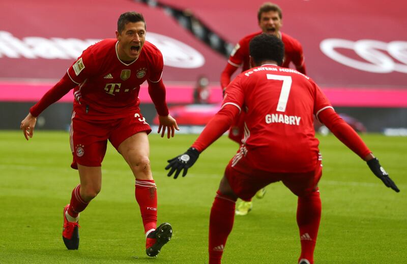 Robert Lewandowski, left, celebrates with Serge Gnabry after scoring Bayern Munich's opening goal in their 4-0 Bundesliga win over Stuttgart at the Allianz Arena on Saturday, March 20. AP