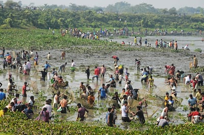 Villagers fish in the water after a barrage built on the river Teesta was opened for maintenance, on the outskirts of Siliguri, India. An agreement with Bangladesh on sharing the river's water has yet to be signed.  AFP
