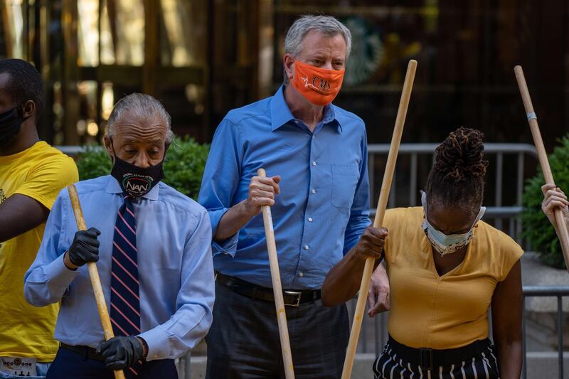 New York City Mayor Bill de Blasio, his wife Chirlane McCray and Reverend Al Sharpton help paint a Black Lives Matter mural on Fifth Avenue directly in front of Trump Tower. Getty Images/AFP