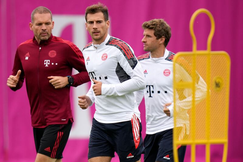 Bayern's Leon Goretzka, centre, Thomas Mueller and fitness coach Holger Broich. AP