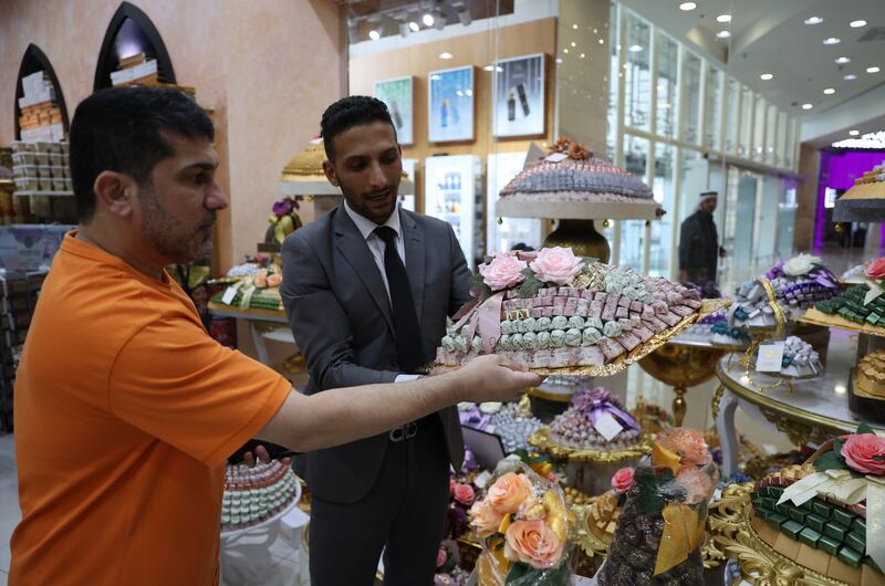 A customer buys chocolates from a Dubai sweet shop for Eid Al Fitr, which begins in the UAE on Friday. EPA