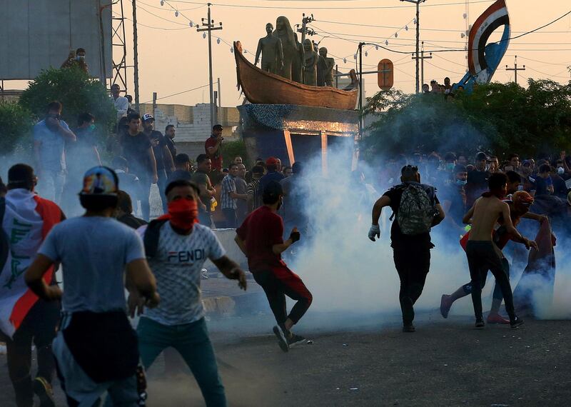 Iraqi security forces fire tear gas during ongoing anti-government protests in Basra. AP Photo