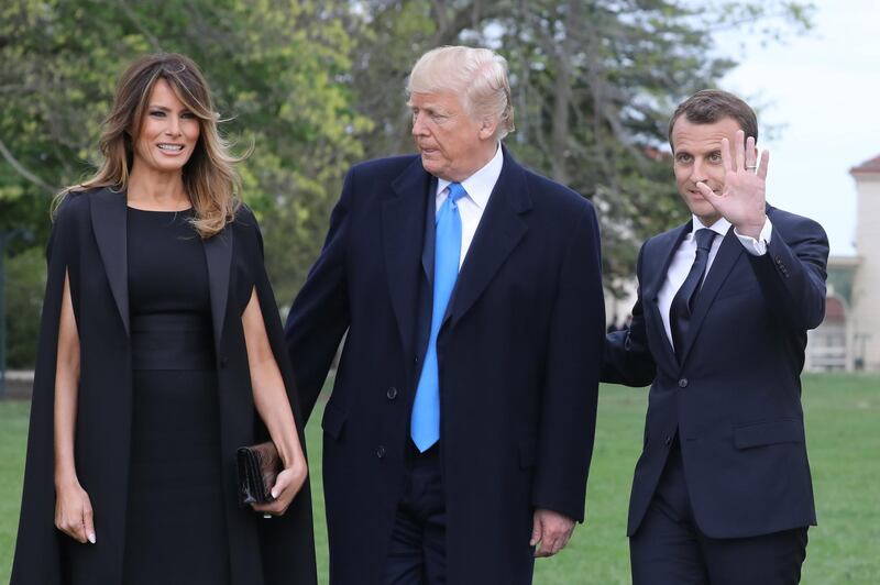 French President Emmanuel Macron stands with US President Donald Trump and US first lady Melania Trump at Mount Vernon, the estate of the first US President George Washington, in Mount Vernon, Virginia, on April 23, 2018. Ludovic Marin / AFP